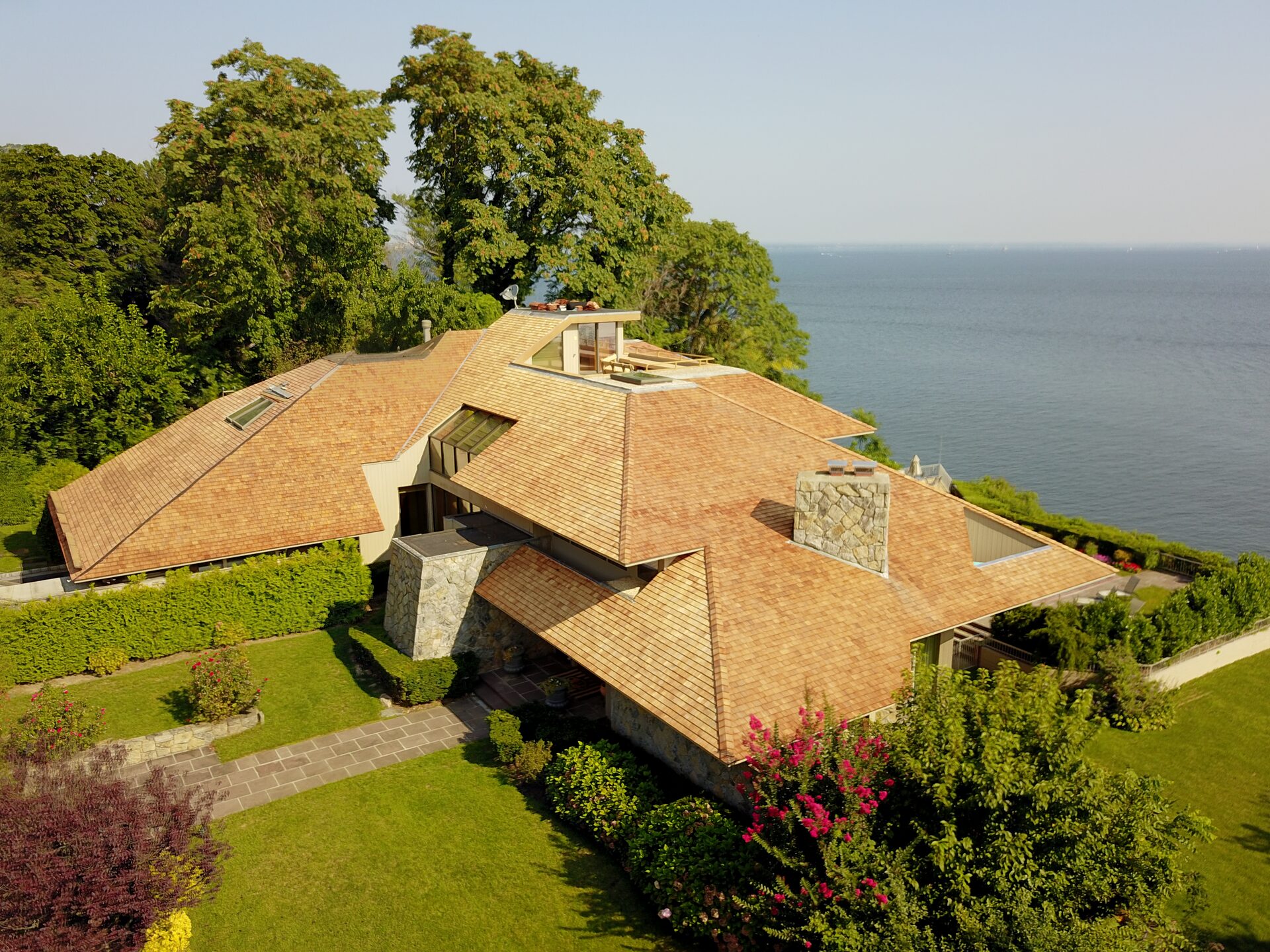 Drone view of a waterfront home's cedar roof